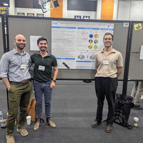 Poster of three scientists standing in front of a poster at an academic conference